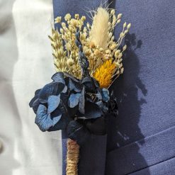 Boutonnière de marié en fleurs séchées bleu pour mariage champêtre